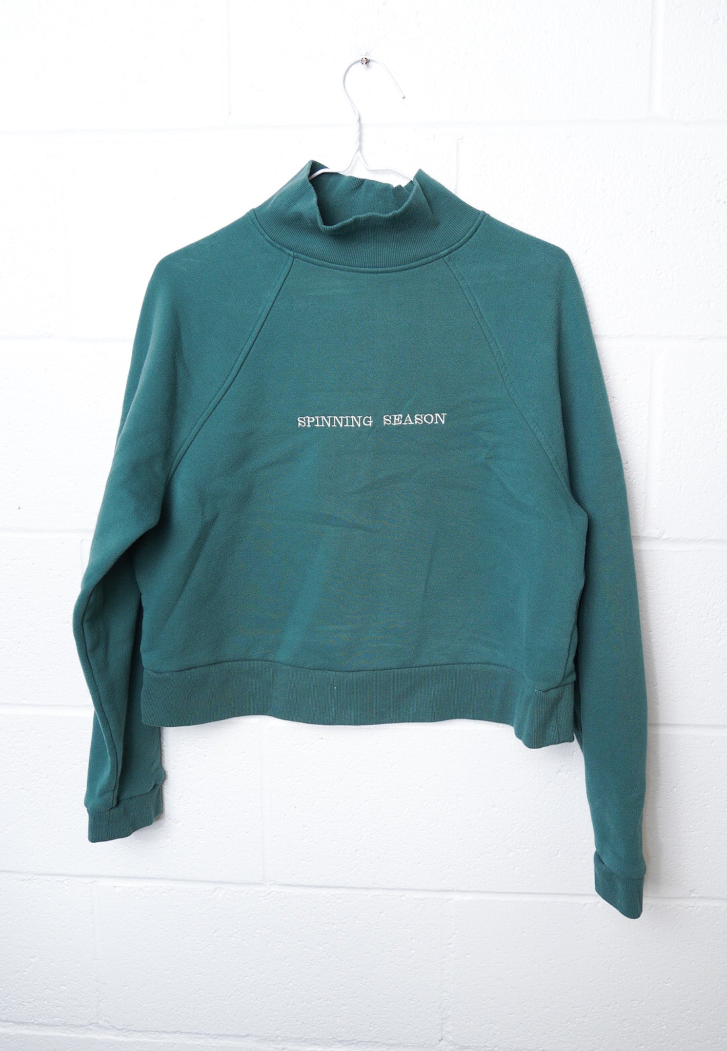MEDIUM Green Mock Neck Crop with "Spinning Season" design