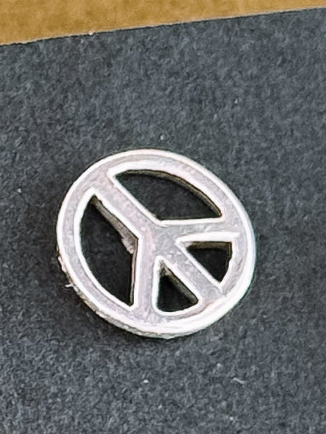 Set of silver earrings on a black card with a textured surface